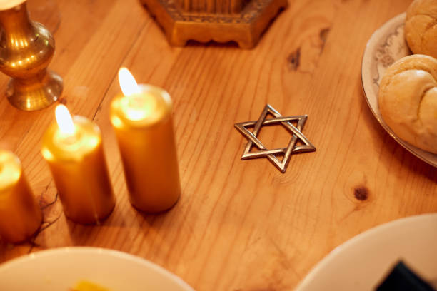 Close-up of Jewish dining table with star of David during Hanukkah meal.