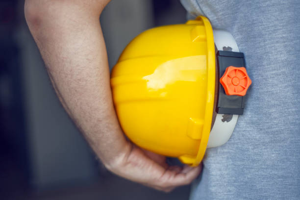 istock A manufacturing worker holding a yellow safety helmet 1337100681