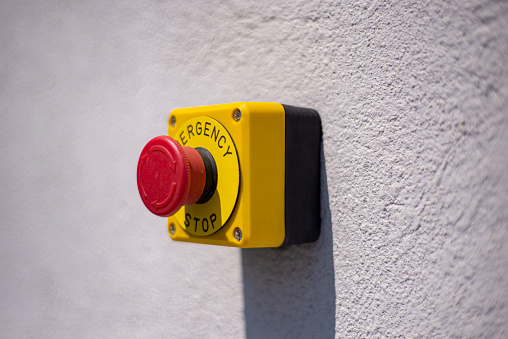 A yellow emergency button on the wall