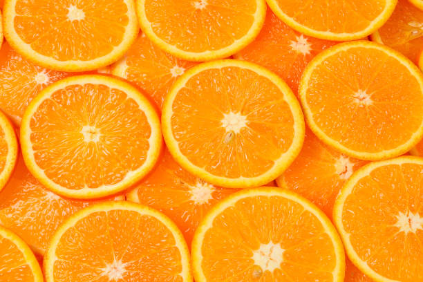 istock Slices of oranges as a background, top view. 1337102878