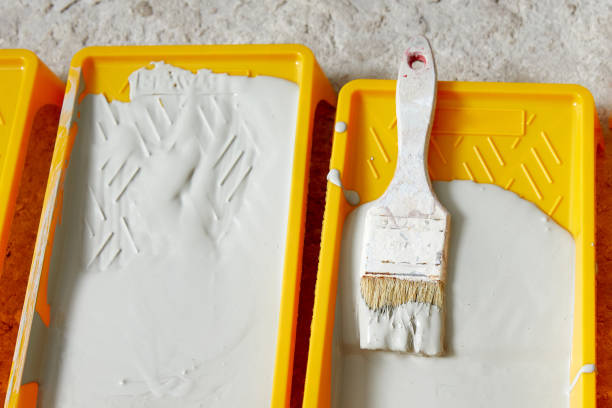 istock paint tray filled with gray paint an brush. Tools for the painter and redecoration 1337104145