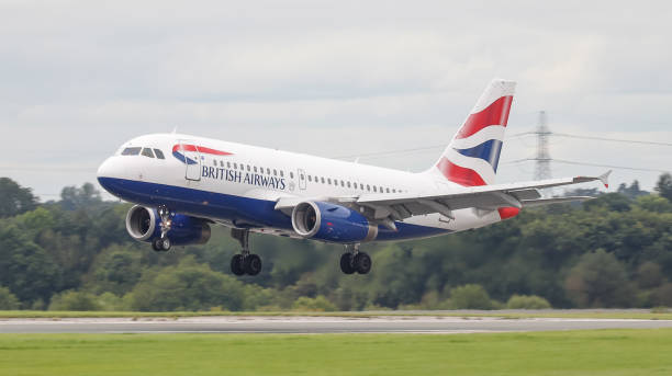 British Airways Airbus 319 at Manchester Airport. Manchester, United Kingdom - August 27, 2021: British Airways Airbus 319 (G-EUPO) touching down on arrival on RW 05L at Manchester Airport. british airways stock pictures, royalty-free photos & images