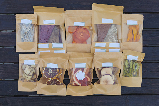 Dried fruits packaged in eco-friendly paper bags. Healthy desserts concept. Natural substitutes for sugar in the diet.