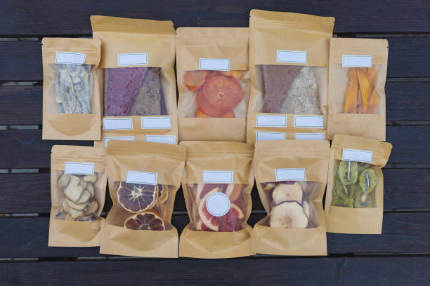 dried fruits packaged in eco-friendly paper bags. healthy desserts concept - packaged food imagens e fotografias de stock