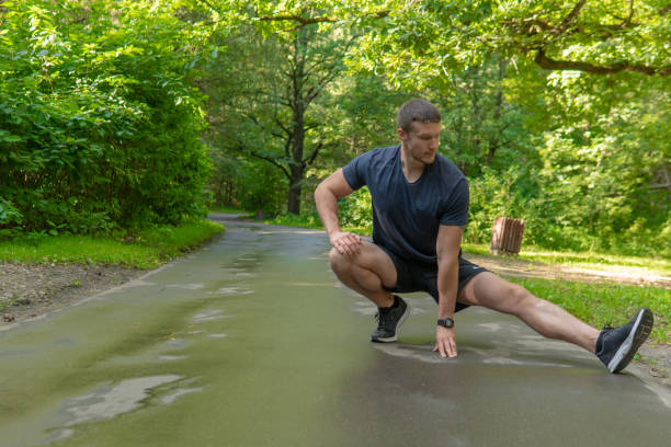 istock A young enduring athletic athlete is doing stretching in the forest outdoors, around the forest, oak trees.active runner forest, jogger athletic park wellbeing. running, morning stretches 1337110583