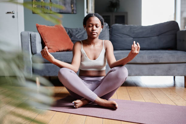 istock Young Woman Doing Yoga at Home 1337113337