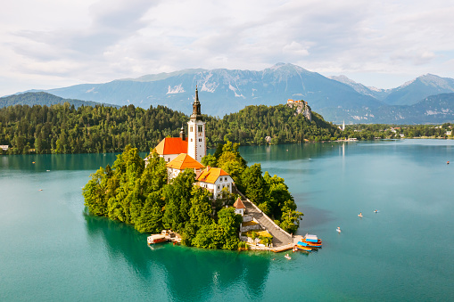 Panoramic view of Lake Bled with Assumption of Maria Church on island on the background of Julian Alps mountains in Slovenia.