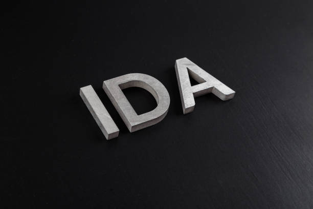 istock the word ida laid with silver metal letters over dry black matte surface 1337115698