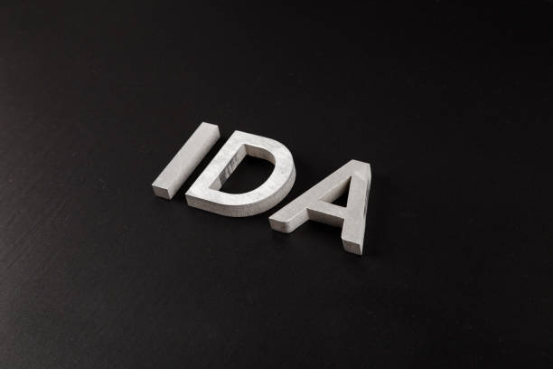 istock the word ida laid with silver metal letters over dry black matte surface 1337115721