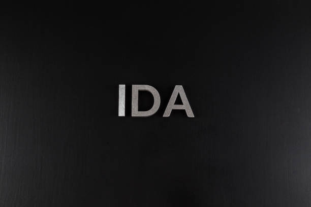 istock the word ida laid with silver metal letters over dry black matte surface 1337115723