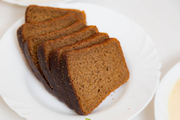 istock Sliced black bread on a plate. Culinary background with selective focus 1337118857