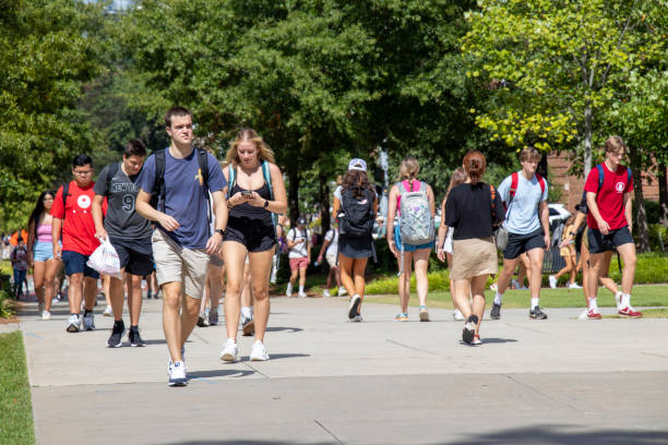 Students walking outside on a bright sunny day on campus at the University of Georgia stock photo