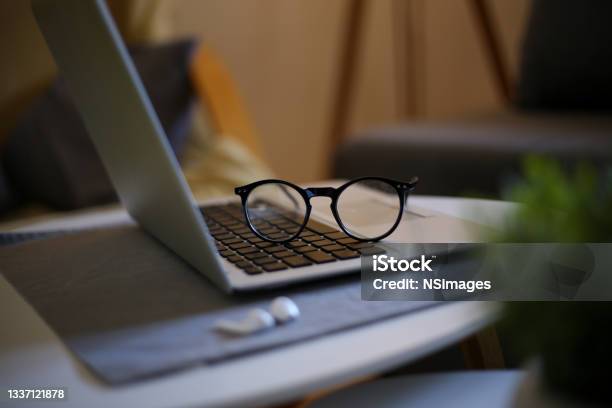 Side View Of Office Desk With Glasses Laptop And Other Items Stock Photo Stock Photo - Download Image Now