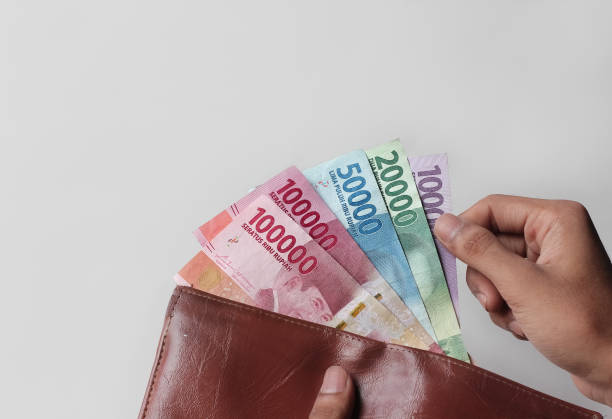 istock hand showing rupiah money from wallet isolated on white background 1337122468