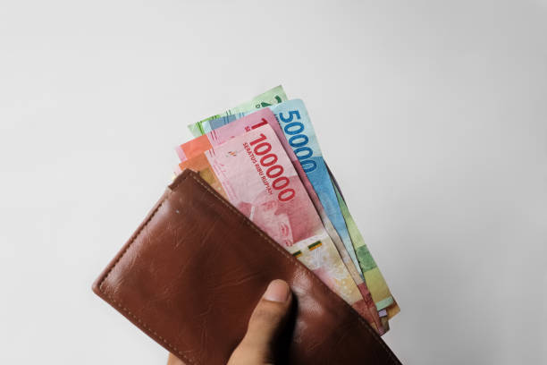 istock hand showing rupiah money from wallet isolated on white background 1337122493