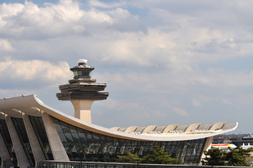 A good view of the Dulles airport terminal with the control tower in the background.