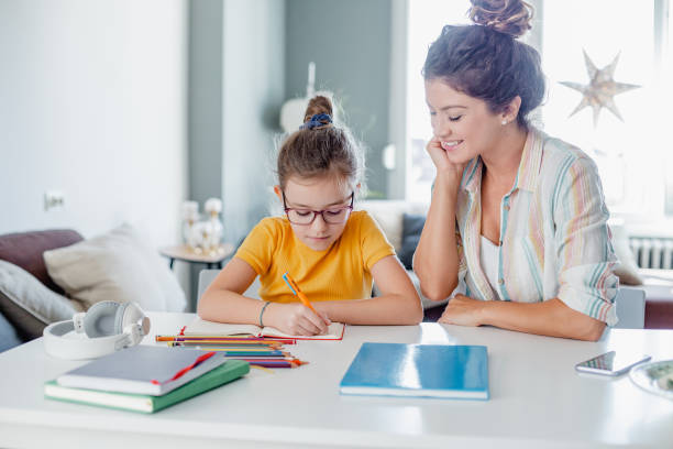 istock Mother helps her daughter study for school 1337126425