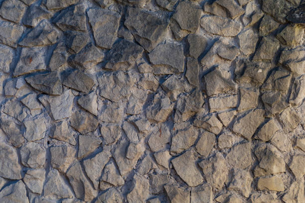 istock The rough textured surface of the wild stone wall. 1337126466