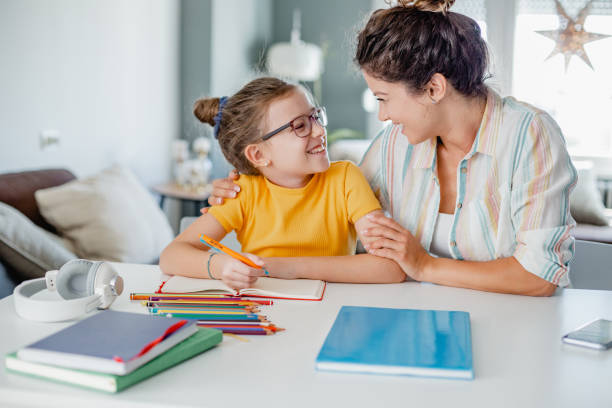 istock Mother helps her daughter study for school 1337126506