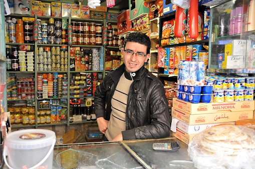 Marrakech, Morocco - march 16, 2012: Man inside a grocery stall in the Medina of the old city