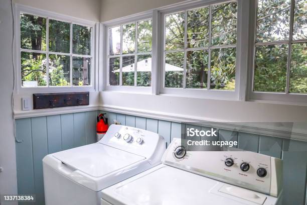 A Vintage Laundry Room Filled With Windows And Natural Light Stock Photo - Download Image Now