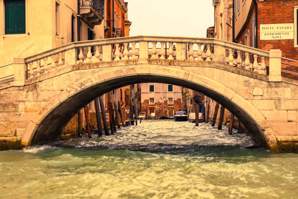 Venice, Italy - February 16 2016 : The best way to go to Venice is by boat as one has the best view then. Here we see a bridge over a small canal.