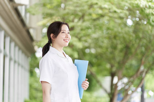 istock Nurse standing with a smile on a green background 1337145760