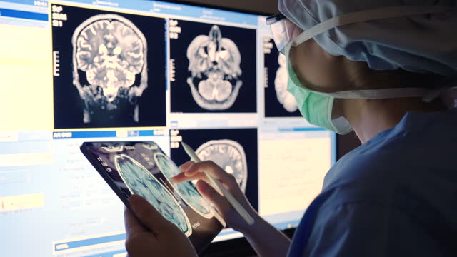 Doctor radiologist using computer at MRI Scan