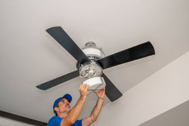 Removing the light cover on a fan Man removes glass light cover on a ceiling fan inside of a home ceiling fan stock pictures, royalty-free photos & images