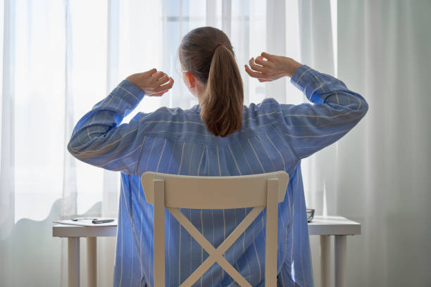 istock Unrecognizable woman stretching after long-hours working from home. Remote work difficulties 1337159330