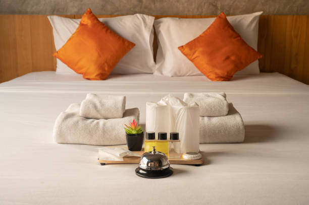 istock Set of hotel amenities (such as towels, shampoo, soap etc.) on the bed. 1337163727