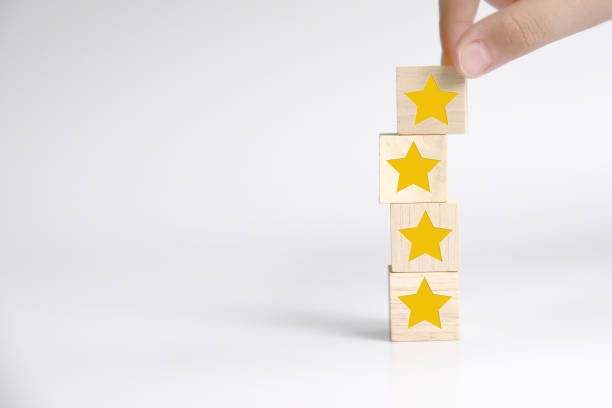 istock Hand building wood block cube stacking on top with five star shape. The best excellent business services rating customer experience concept 1337163838
