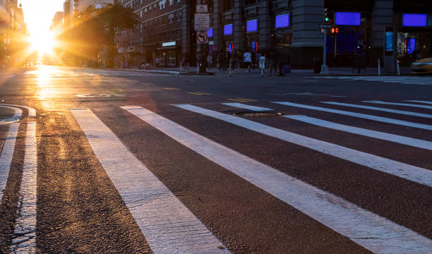istock Empty intersection on 14th Street and 5th Avenue with light of sunset shining between the background buildings in New York City 1337164743