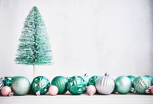 Christmas Background with Green Bottle Brush Tree and Green and Pink Holiday Decorations