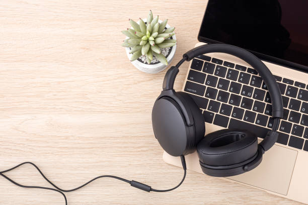 istock Headphone on laptop on wooden desk 1337166911