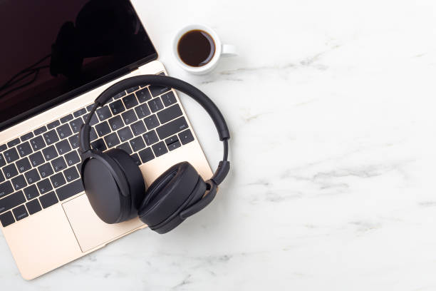 istock Headphone on gold laptop with coffee cup 1337167117