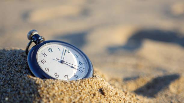 istock A pocket watch that ticks on the beach 1337169186