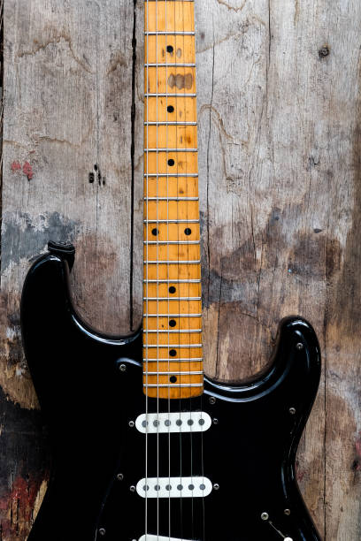 istock Black Electric Guitar on a wood background. 1337171950