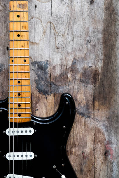 istock Black Electric Guitar on a wood background. 1337171955