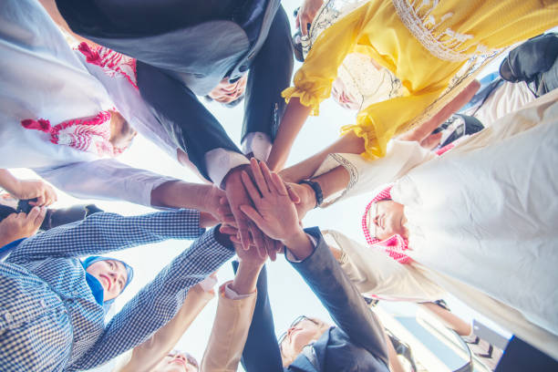istock Diverse multiethnic Partners hands together teamwork group of multi racial people meeting join hands togetherness. Diversity people hands join empower partnership teams connection volunteer community 1337173430
