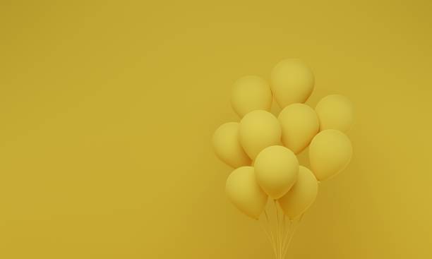 istock Festive balloons on yellow background 1337174559