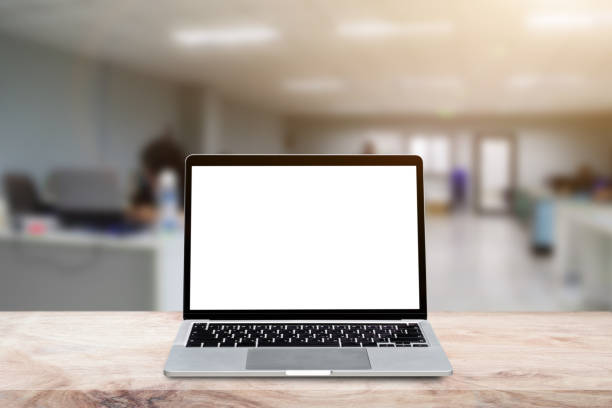 istock Laptop computer with blank screen on wood table over blur background 1337175595