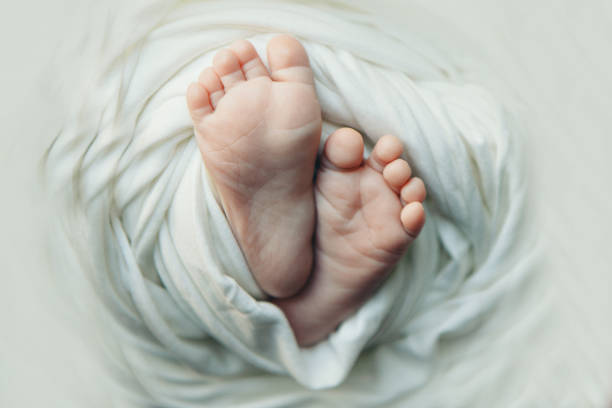 istock baby feet close up on white background 1337175706