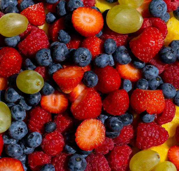 istock Fresh fruit salad. Grapes, blueberries, raspberries and strawberries. View from the top. Background of healthy fresh fruits. Summer time 1337176554