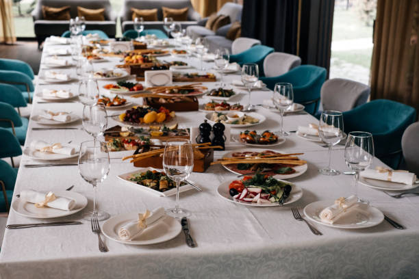 istock Glasses and plates on long table in restaurant for celebration 1337176600