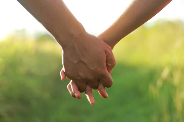 istock Man with a young woman holding hands walking 1337177427