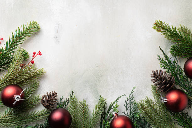 Christmas frame with fir tree branches on light wooden background