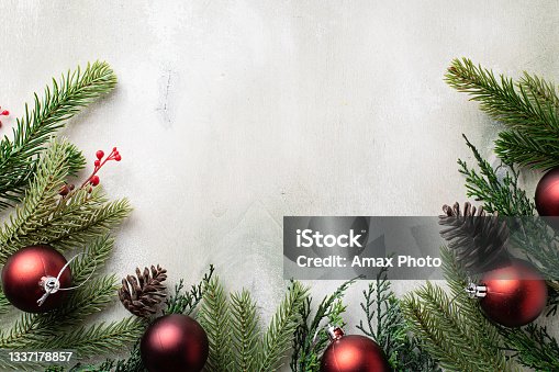 istock Christmas frame with fir tree branches on light wooden background 1337178857