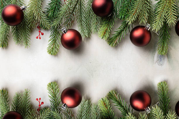 istock Christmas frame with fir tree branches on light wooden background 1337178965