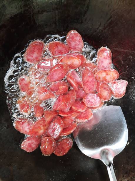 istock Frying Chinese sausage in iron cooking pan. 1337178996